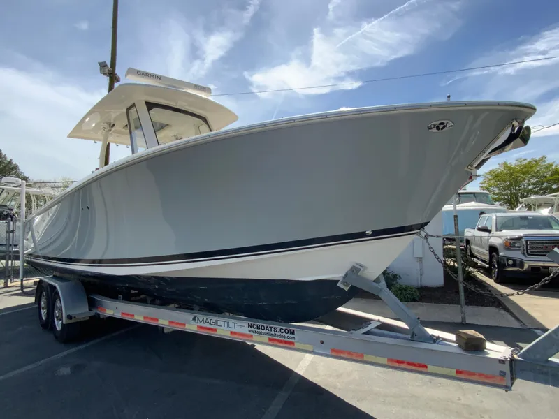 Slide: The Image of 2020 Pursuit S 288 Sport boat on trailer under clear sky. - 2
