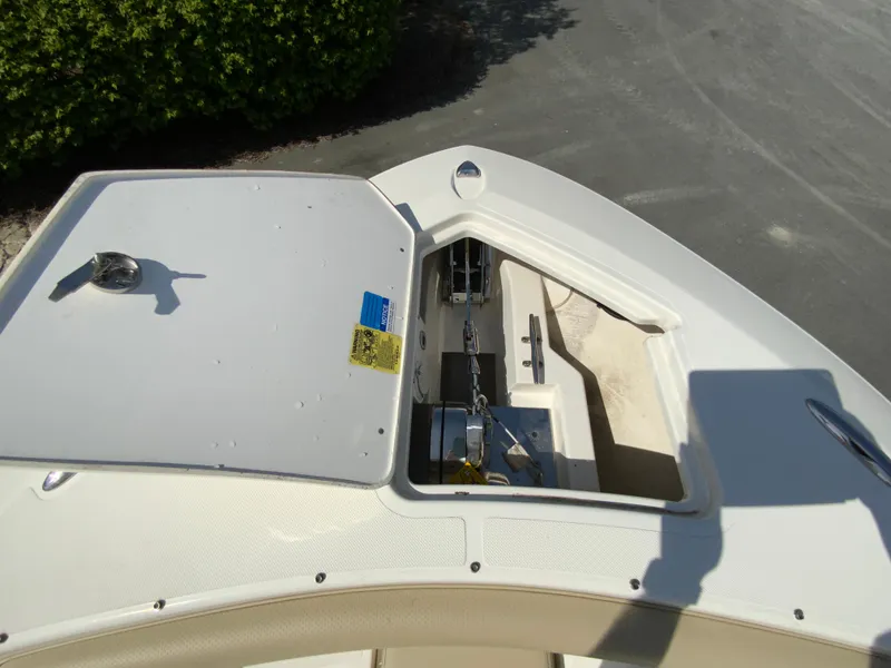 Slide: The Image of 2020 Pursuit S 288 Sport boat anchor compartment, open lid, showing anchor chain and storage. - 21