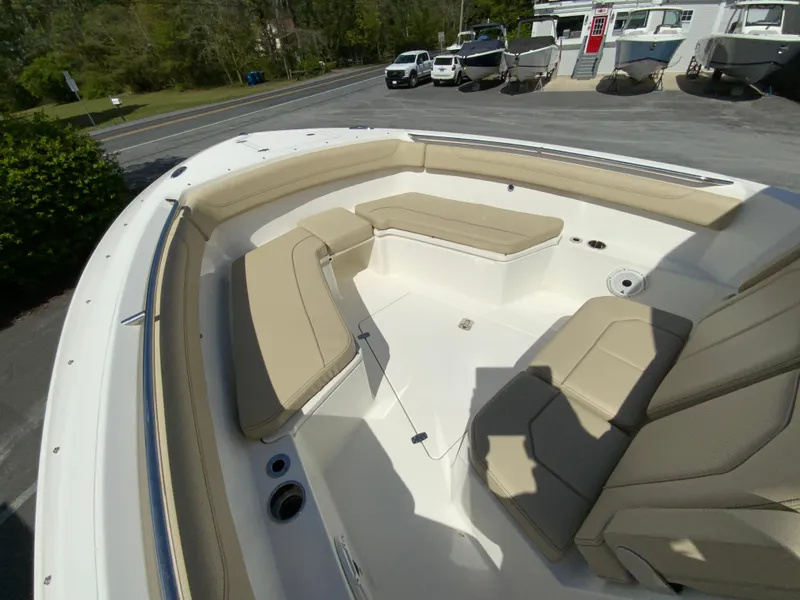 Slide: The Image of 2020 Pursuit S 288 Sport boat with beige seating in a parking lot. - 22