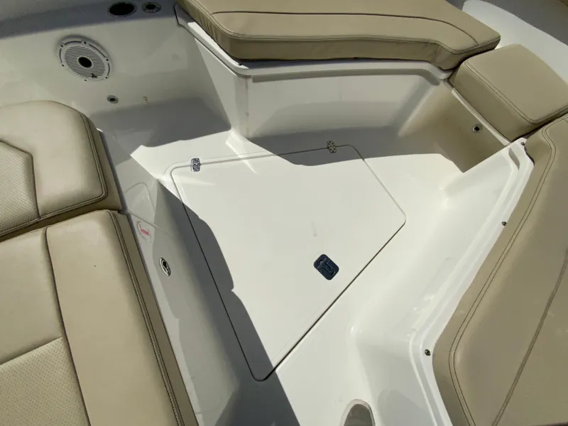 Slide: The Image of 2020 Pursuit S 288 Sport boat interior with beige seating and storage compartment. - 25