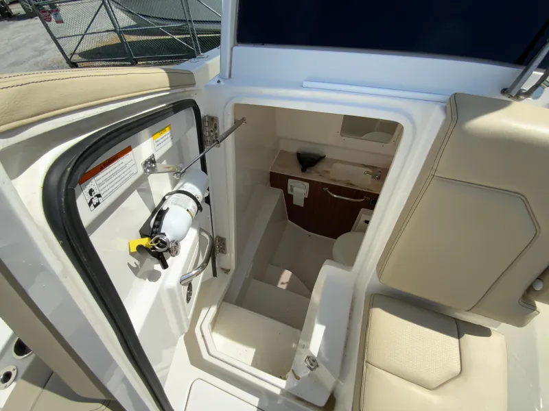 Slide: The Image of Interior view of 2020 Pursuit S 288 Sport boat, featuring a compact cabin space. - 28