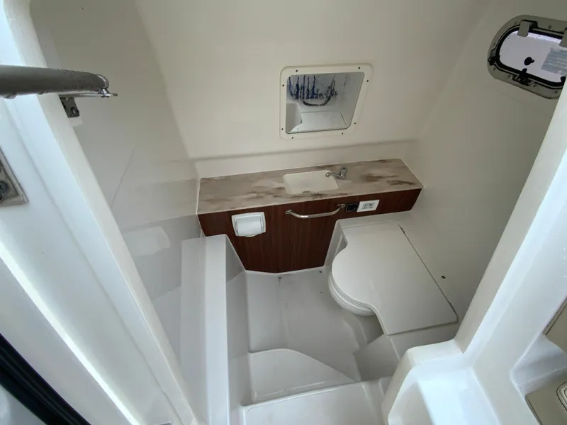 Slide: The Image of 2020 Pursuit S 288 Sport boat interior bathroom with sink and toilet. - 30