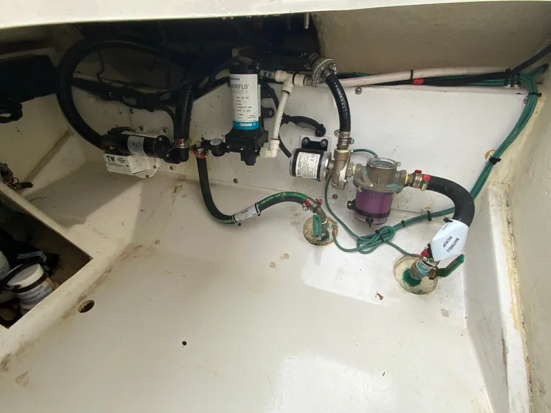 Slide: The Image of 2020 Pursuit S 288 Sport boat engine compartment with visible hoses and components. - 35