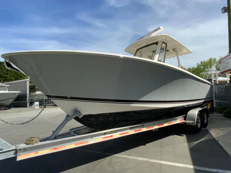 Slide: The Image of 2020 Pursuit S 288 Sport boat on trailer under clear sky. - 4