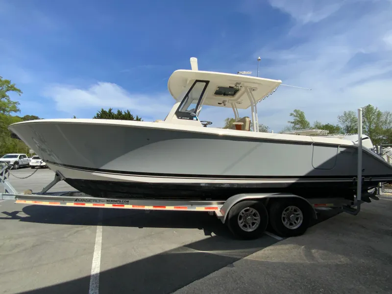 Slide: The Image of 2020 Pursuit S 288 Sport boat on trailer under clear blue sky. - 5