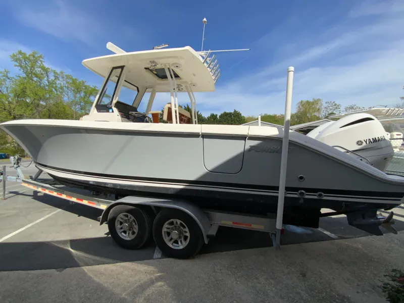 Slide: The Image of 2020 Pursuit S 288 Sport boat on trailer with Yamaha engines, parked outdoors. - 6
