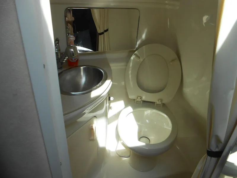 Slide: The Image of 2008 Sea Ray 280 Sundancer bathroom with toilet, sink, and mirror. - 13