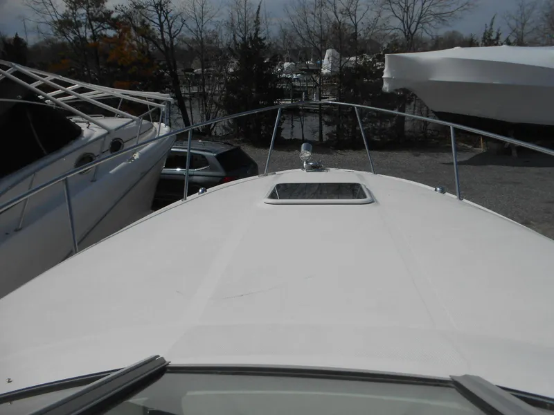 Slide: The Image of 2008 Sea Ray 280 Sundancer boat deck with hatch, docked in marina. - 14