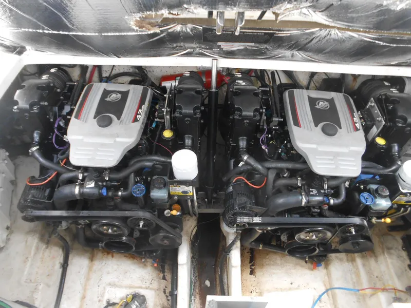 Slide: The Image of Twin engines of a 2008 Sea Ray 280 Sundancer boat, showcasing detailed mechanical components. - 17