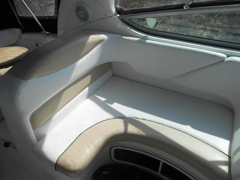 Slide: The Image of Interior seating of 2008 Sea Ray 280 Sundancer boat, featuring beige and white upholstery. - 6