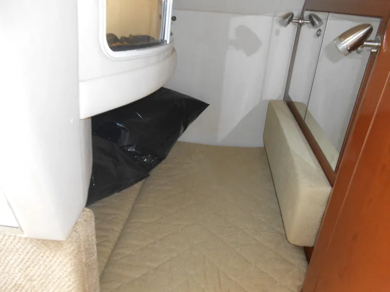 Slide: The Image of Interior cabin of 2008 Sea Ray 280 Sundancer boat, featuring seating and storage. - 9