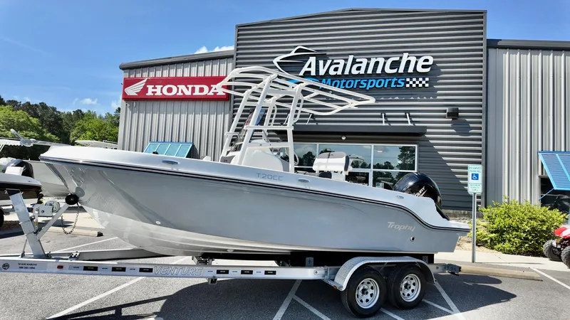 The Image of 2025 Bayliner Trophy 20 boat on trailer at Avalanche Motorsports dealership. - 0