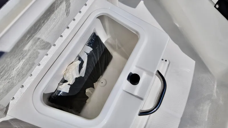 Slide: The Image of Storage compartment in 2025 Bayliner Trophy 20 boat, featuring a secure latch and handle. - 10