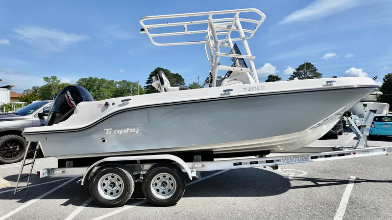 Slide: The Image of 2025 Bayliner Trophy 20 boat on trailer, parked in a lot under clear skies. - 18