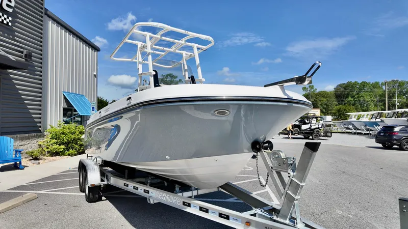 Slide: The Image of 2025 Bayliner Trophy 20 boat on trailer, parked outdoors under clear blue sky. - 19