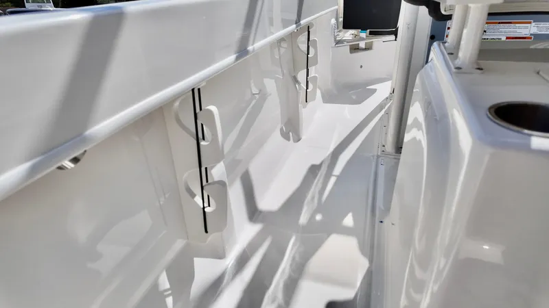 Slide: The Image of 2025 Bayliner Trophy 20 boat interior with rod holders and sleek white finish. - 3