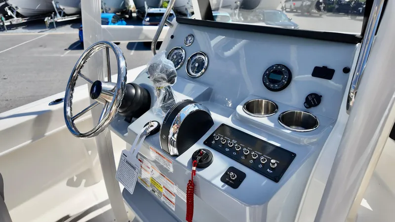 Slide: The Image of 2025 Bayliner Trophy 20 boat dashboard with steering wheel and control panel. - 7