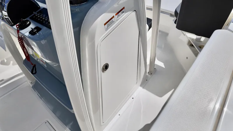 Slide: The Image of 2025 Bayliner Trophy 20 boat interior, featuring helm console and storage compartment. - 9