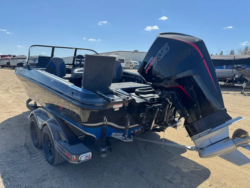 Slide: The Image of 2025 Nitro ZV20 Sport Pro boat with powerful outboard motor, parked on a trailer. - 2