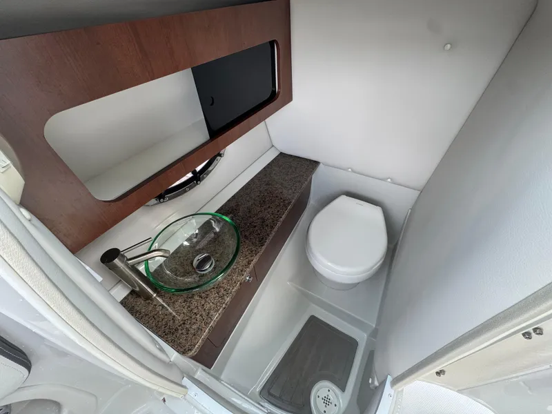 Slide: The Image of 2019 Crownline 290 XSS boat bathroom with modern sink and toilet. - 11