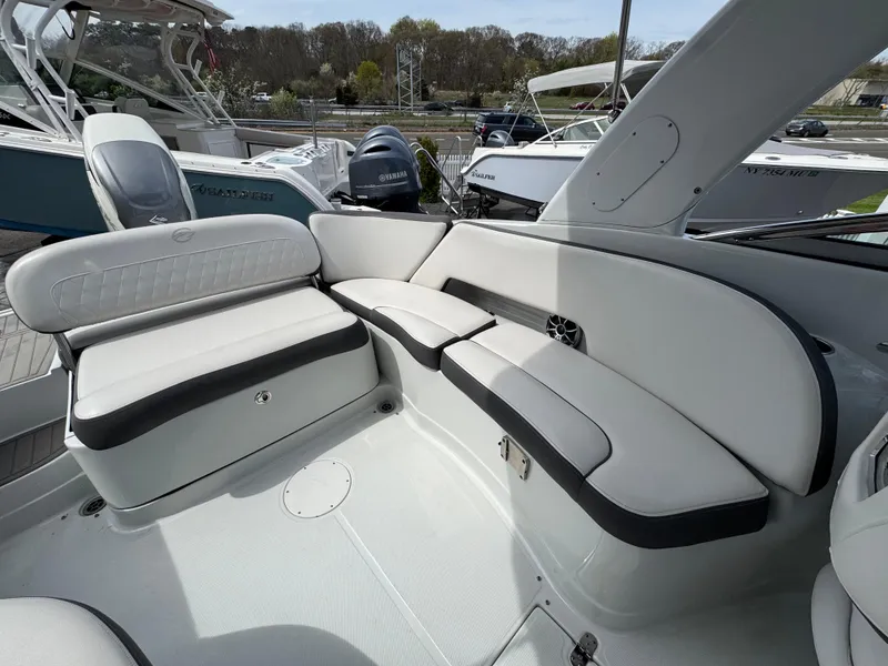 Slide: The Image of 2019 Crownline 290 XSS boat interior with white seating and black trim. - 13