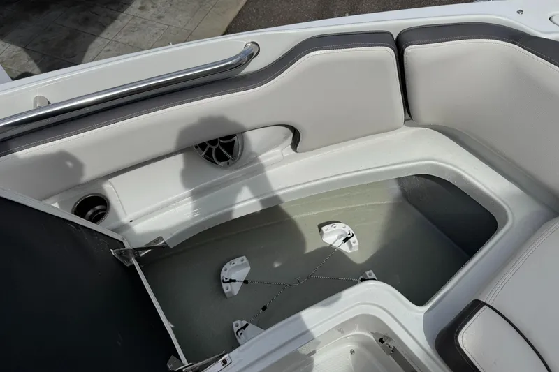 Slide: The Image of 2019 Crownline 290 XSS boat interior with storage compartment and seating area. - 3