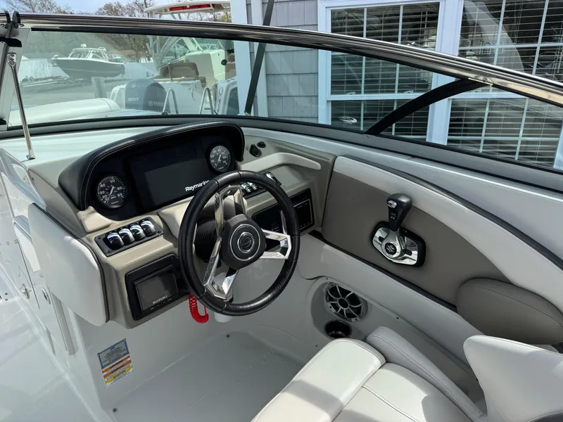 Slide: The Image of 2019 Crownline 290 XSS boat cockpit with steering wheel and control panel. - 8