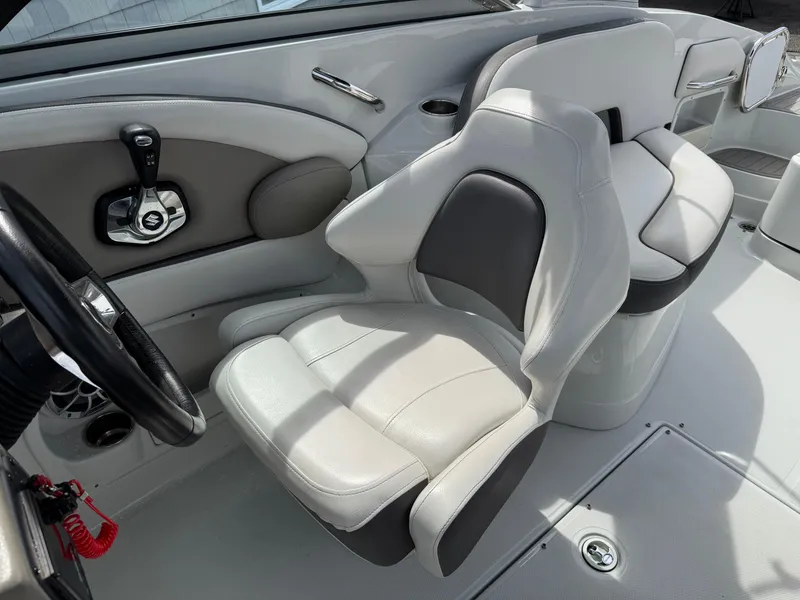 Slide: The Image of 2019 Crownline 290 XSS boat interior with sleek, modern seating and control panel. - 9