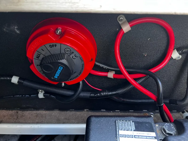 Slide: The Image of Red battery switch in a 2001 Glastron GS 229 boat, featuring Perko brand. - 10