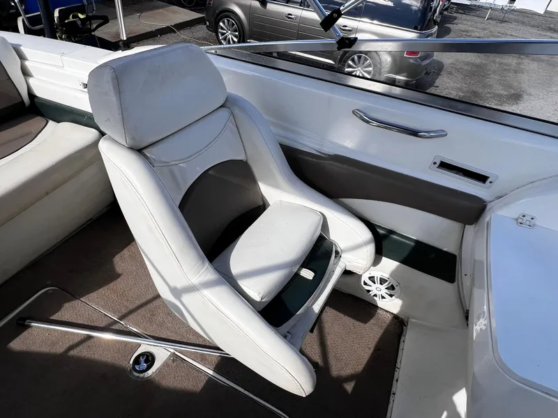 Slide: The Image of 2001 Glastron GS 229 boat interior with white captain's chair and dashboard. - 5