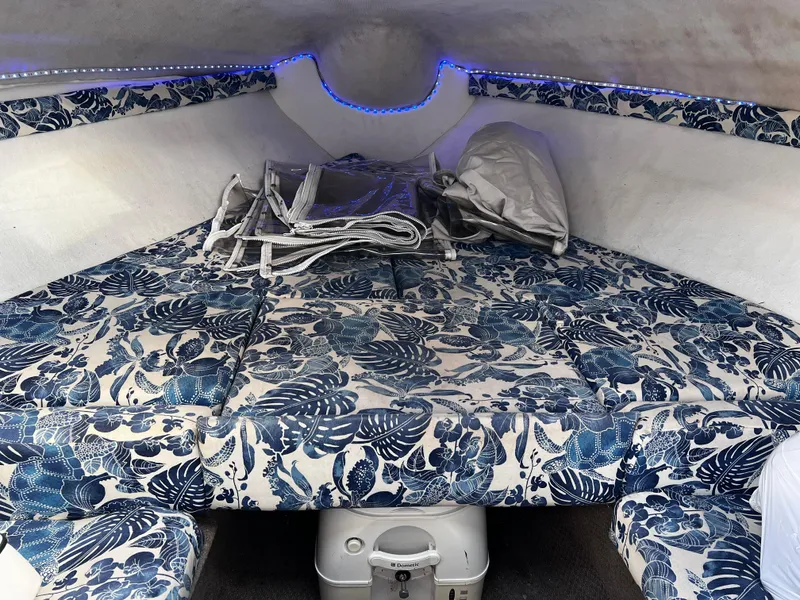 Slide: The Image of 2001 Glastron GS 229 cabin interior with floral upholstery and blue LED lighting. - 8