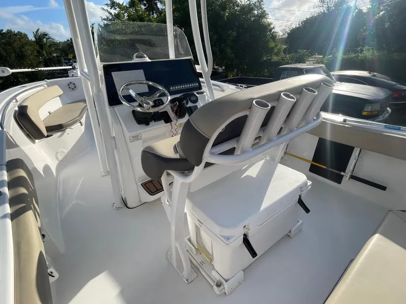 Slide: The Image of 2022 Tidewater Adventure boat interior with steering console and seating. - 10