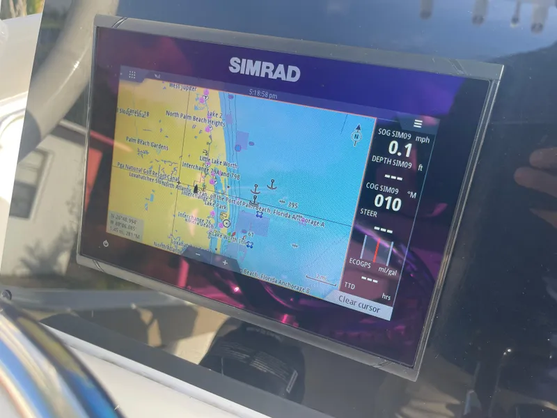 Slide: The Image of Simrad navigation display on 2022 Tidewater Adventure boat, showing map and speed data. - 12