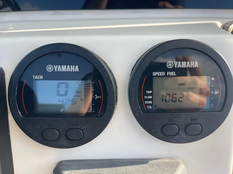 Slide: The Image of Yamaha tachometer and speed fuel gauges on 2022 Tidewater Adventure boat dashboard. - 14