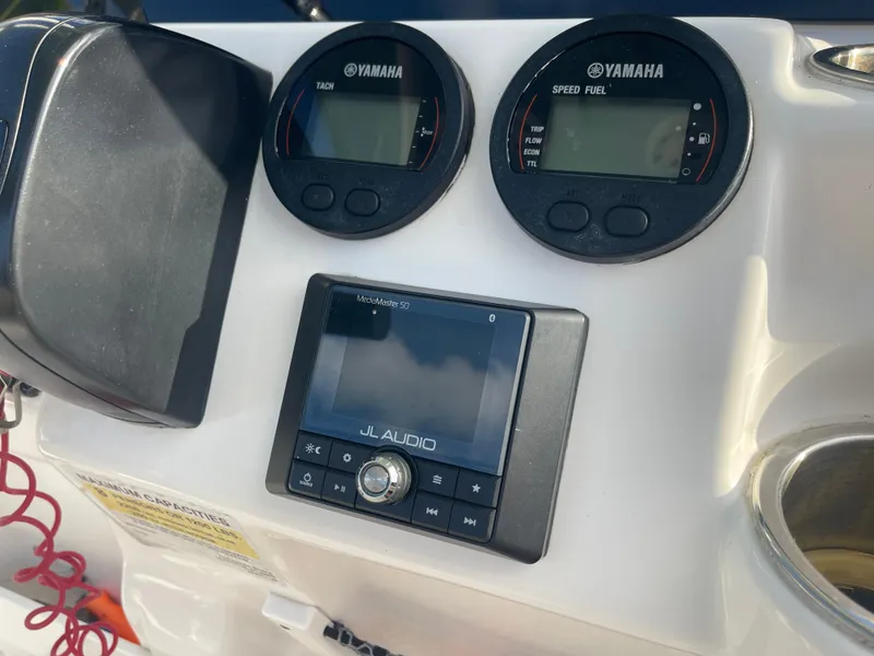Slide: The Image of Control panel of 2022 Tidewater Adventure boat with Yamaha gauges and JL Audio system. - 15