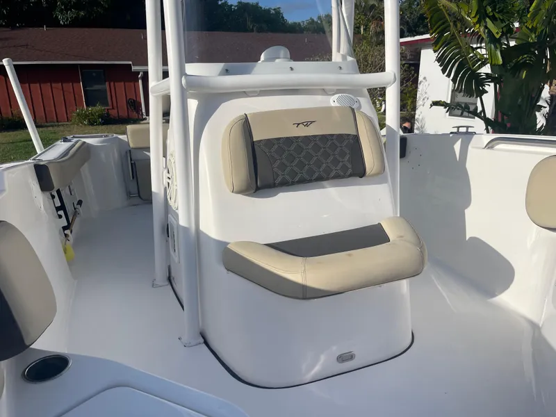 Slide: The Image of 2022 Tidewater Adventure boat interior with cushioned seating and sleek design. - 16
