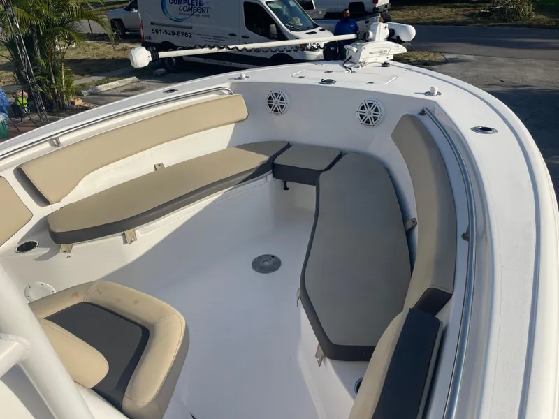 Slide: The Image of 2022 Tidewater Adventure boat interior with beige seating and white deck. - 18