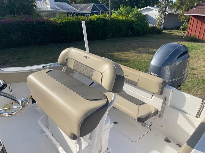 Slide: The Image of 2022 Tidewater Adventure boat interior with seating and Yamaha outboard motor. - 19