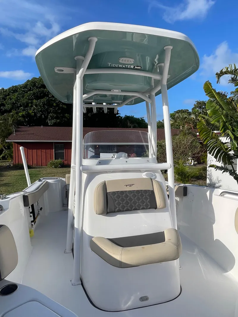 Slide: The Image of 2022 Tidewater Adventure boat with T-top and seating, set against a sunny outdoor backdrop. - 2