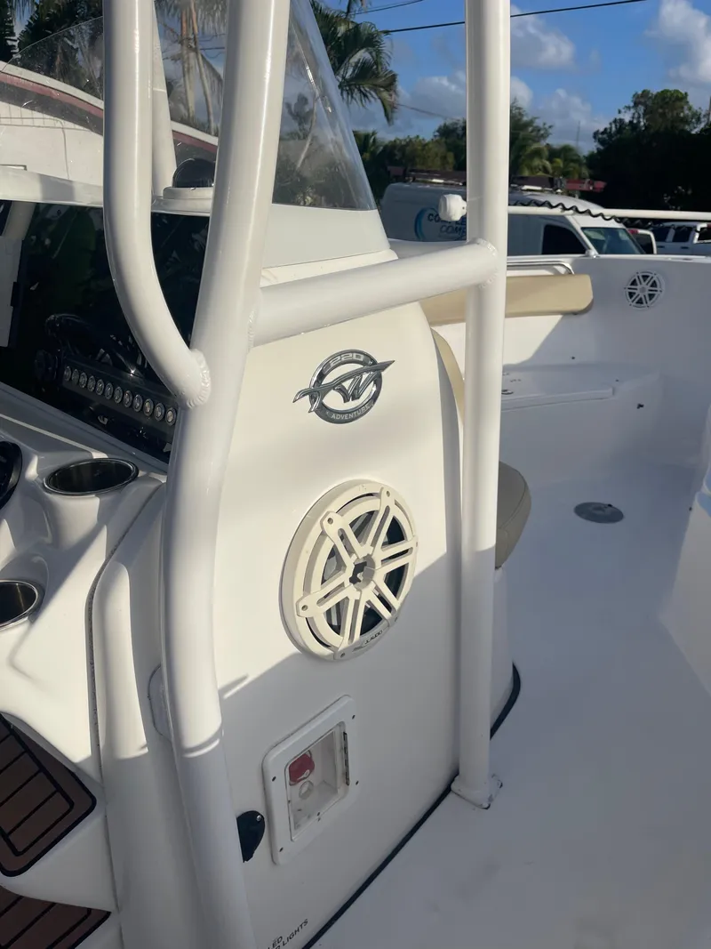 Slide: The Image of 2022 Tidewater Adventure boat interior with speaker and control panel, under clear blue sky. - 20