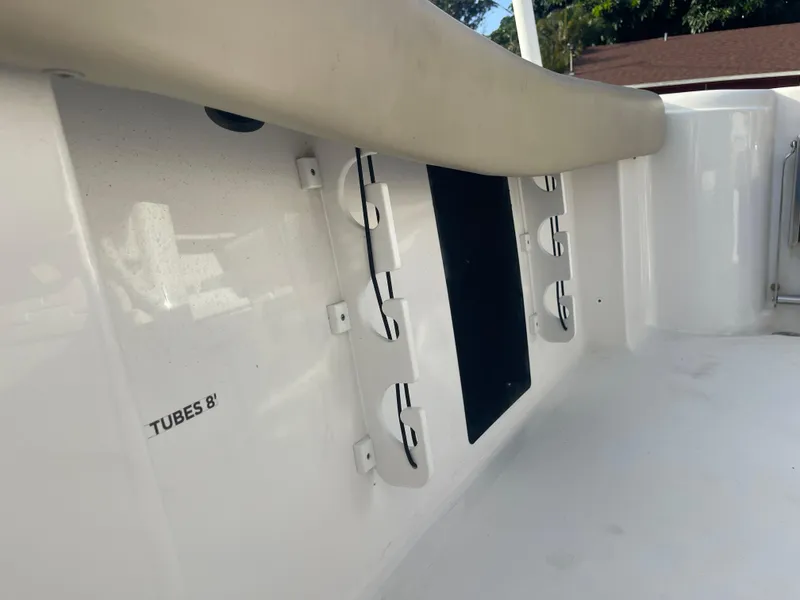 Slide: The Image of Interior view of a 2022 Tidewater Adventure boat, featuring rod holders and storage space. - 21