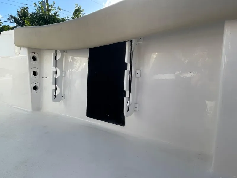Slide: The Image of 2022 Tidewater Adventure boat interior with rod holders and storage compartment. - 22