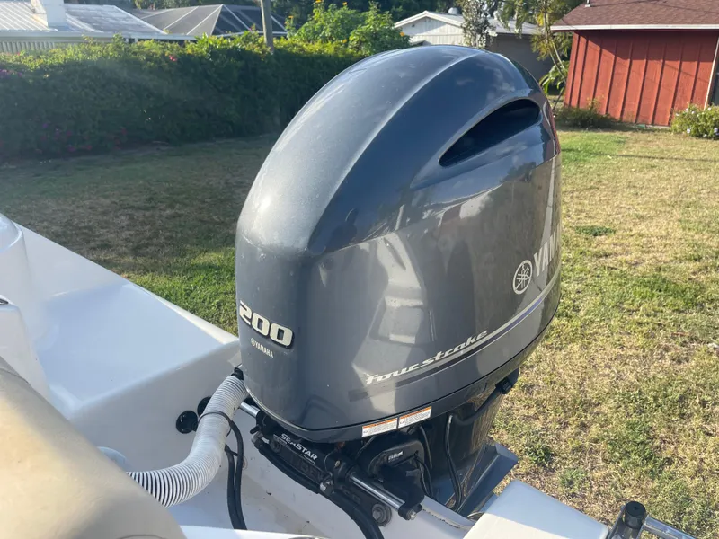 Slide: The Image of 2022 Tidewater Adventure boat with Yamaha 200 four-stroke outboard motor in a backyard setting. - 29