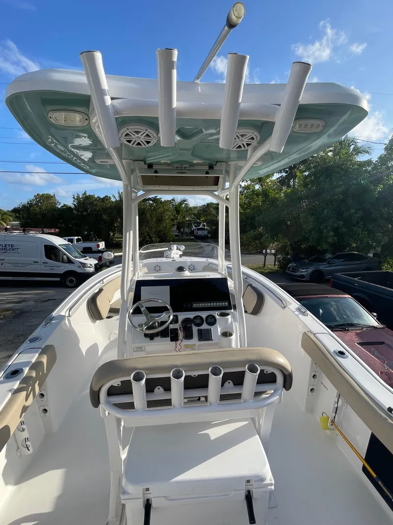 Slide: The Image of 2022 Tidewater Adventure boat interior with helm, rod holders, and seating under a clear blue sky. - 3