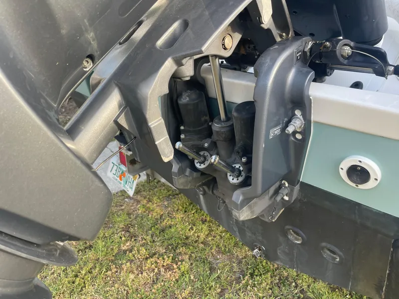 Slide: The Image of 2022 Tidewater Adventure boat engine close-up, showcasing mechanical components and Florida license plate. - 31