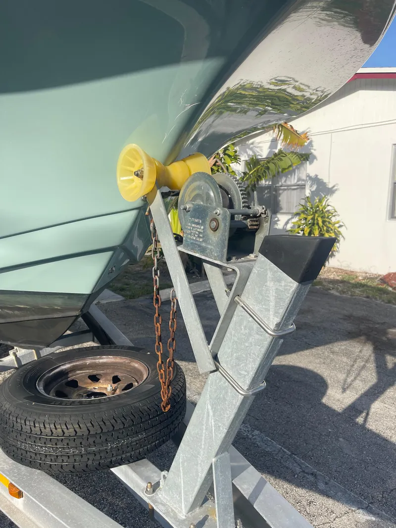Slide: The Image of 2022 Tidewater Adventure boat on trailer with winch and tire, parked outdoors. - 35