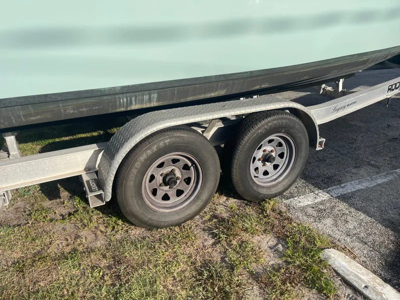 Slide: The Image of Trailer with dual wheels carrying a 2022 Tidewater Adventure boat. - 37