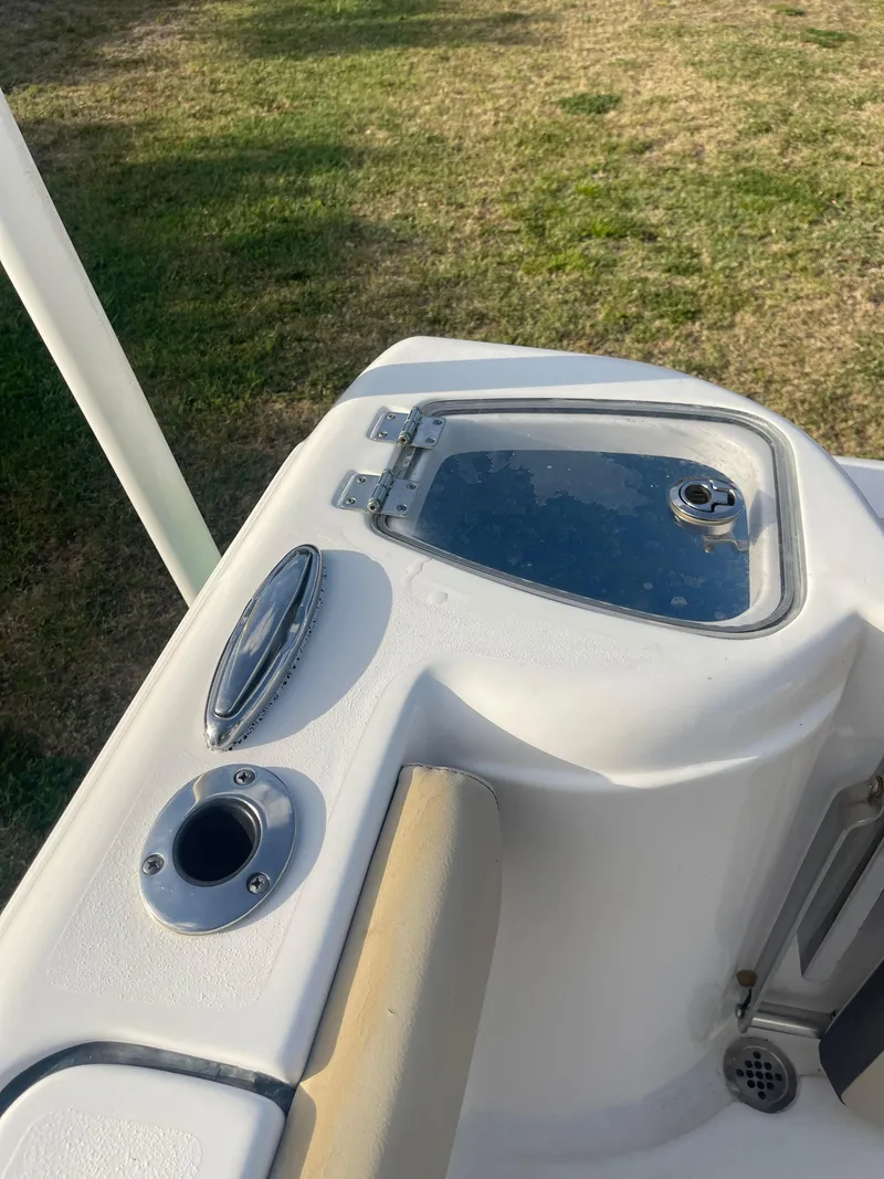Slide: The Image of 2022 Tidewater Adventure boat deck with storage compartment and rod holder. - 38