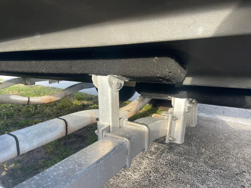 Slide: The Image of 2022 Tidewater Adventure boat trailer with padded supports on a sunny day. - 40