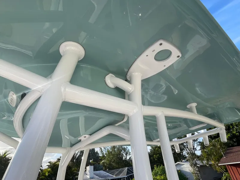 Slide: The Image of 2022 Tidewater Adventure boat canopy with white support poles and blue sky background. - 5